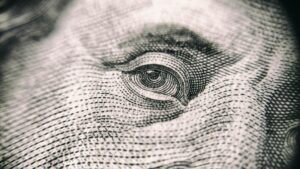 Close-up of eye detail on a dollar bill, symbolizing financial focus and creditors' rights within California's legal framework for recovering debts.