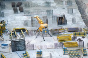 A construction site with rebar and equipment, symbolizing the challenges of managing payment disputes and the importance of debt collection in California's construction industry.