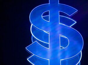 Glowing blue neon dollar sign on a dark background, symbolizing financial recovery and the goal of collecting on a legal judgment.