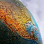 Globe highlighting California and western United States for international debt collection context.