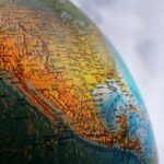 Tilted view of a globe highlighting the western U.S. and Central America, symbolizing the cross-border legal process of enforcing international or foreign judgments in California